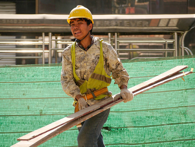 Construction workers build a section of a highway in Yangon. Because of Yangon's status as the nation's business hub, construction has become a major source of employment for many Yangon residents. Photo by Asian Development Bank, Flickr. Taken 5 March 2015. Licensed under CC BY-NC-ND 2.0.